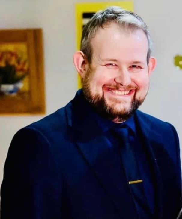 Freedom Formula Hypnotherapy Academy trainer smiling in a suit